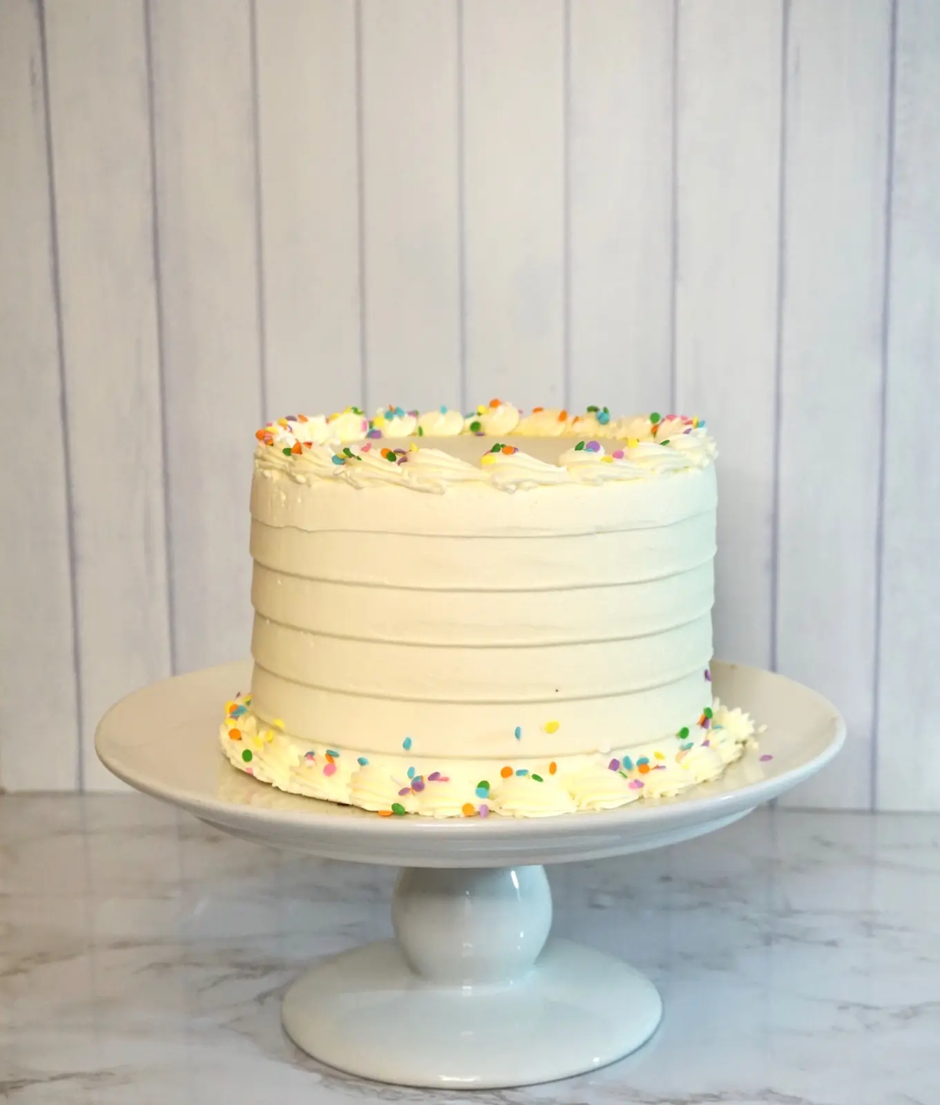 Basic Betty cake with white buttercream and confetti trim